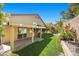 The manicured backyard boasts a covered patio and lush garden, creating a private outdoor oasis at 2329 Sunrise Meadows Dr, Las Vegas, NV 89134