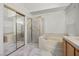 Bathroom featuring a bathtub, glass-enclosed shower, and a vanity with a sink at 2329 Sunrise Meadows Dr, Las Vegas, NV 89134