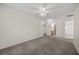 Large bedroom with neutral carpet, a ceiling fan, and multiple doorways to other rooms at 2329 Sunrise Meadows Dr, Las Vegas, NV 89134