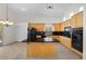 Bright kitchen featuring an island, black appliances, and plenty of cabinet space for all your culinary needs at 2329 Sunrise Meadows Dr, Las Vegas, NV 89134