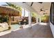 Covered back patio looks out to the pool featuring a grotto, slide, and tiki umbrella table at 25 Blue Valley Dr, Henderson, NV 89002