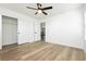 Spacious bedroom with wood-look flooring, closet, and adjacent bathroom, offering style and convenience at 25 Blue Valley Dr, Henderson, NV 89002