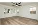 Bright bedroom with natural light, wood floors, and three windows at 25 Blue Valley Dr, Henderson, NV 89002