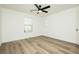 Bright bedroom featuring wood-look floors, modern ceiling fan, and a window for natural light at 25 Blue Valley Dr, Henderson, NV 89002