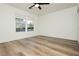 A bedroom featuring hardwood floors, a ceiling fan, and a large window for ample natural light at 25 Blue Valley Dr, Henderson, NV 89002
