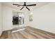 Bright bedroom with sliding glass door and wood-look flooring at 25 Blue Valley Dr, Henderson, NV 89002