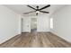 An airy bedroom with hardwood floors, a ceiling fan, and ample natural light, offering a cozy atmosphere at 25 Blue Valley Dr, Henderson, NV 89002