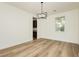 Dining room with a modern chandelier and wood floors, adjacent to kitchen area at 25 Blue Valley Dr, Henderson, NV 89002