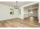 Dining area with modern chandelier, light colored wood floors, and natural light at 25 Blue Valley Dr, Henderson, NV 89002
