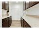Modern kitchen features dark cabinetry, stone countertops and wood-look flooring at 25 Blue Valley Dr, Henderson, NV 89002