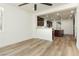 Modern kitchen showcasing dark cabinetry, wood-look floors, and an island at 25 Blue Valley Dr, Henderson, NV 89002