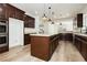 Modern kitchen boasts an island, stainless appliances, and sleek dark cabinets at 25 Blue Valley Dr, Henderson, NV 89002