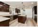 Well-equipped kitchen with stainless steel appliances, island and wood-look floors at 25 Blue Valley Dr, Henderson, NV 89002