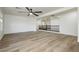 Spacious living room with wood-look floors, neutral paint, and ceiling fan, offering a modern design at 25 Blue Valley Dr, Henderson, NV 89002