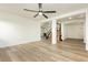 Bright open living space with wood floors, a ceiling fan, and stairs to second floor at 25 Blue Valley Dr, Henderson, NV 89002