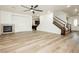 Open living space featuring fireplace, wood-look floors, and staircase at 25 Blue Valley Dr, Henderson, NV 89002
