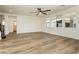 Spacious living room with wood-look floors, ceiling fan, and ample natural light at 25 Blue Valley Dr, Henderson, NV 89002