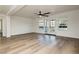 A sunlit living room boasting wood floors, a ceiling fan, and French doors at 25 Blue Valley Dr, Henderson, NV 89002