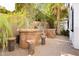 View of the built-in stone outdoor grill area with seating made of custom log stools at 25 Blue Valley Dr, Henderson, NV 89002