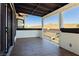 A covered outdoor area features a tiled floor, white walls and provides a private and secluded retreat at 25 Blue Valley Dr, Henderson, NV 89002