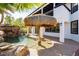 Backyard pool with swim-up tiki umbrella table and attached patio of the two-story home at 25 Blue Valley Dr, Henderson, NV 89002