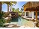 Sparkling backyard pool featuring a rock waterfall, slide, and lush landscaping at 25 Blue Valley Dr, Henderson, NV 89002