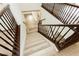 Wooden staircase with a dark wood railing and white risers at 25 Blue Valley Dr, Henderson, NV 89002