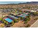 Aerial view showcases the community's tennis and bocce ball courts, surrounded by lush landscaping at 2550 Evening Twilight Ave, Henderson, NV 89044