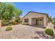 The backyard features desert landscaping, an enclosed block wall, and black metal fence at 2550 Evening Twilight Ave, Henderson, NV 89044