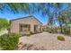 The backyard features desert landscaping, an enclosed block wall, and black metal fence at 2550 Evening Twilight Ave, Henderson, NV 89044