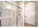 Walk-in shower featuring a glass door and grab bars at 2550 Evening Twilight Ave, Henderson, NV 89044