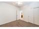 Bright bedroom with neutral carpet, ceiling fan, open doorway, and closet for ample storage at 2550 Evening Twilight Ave, Henderson, NV 89044