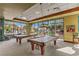 Inviting billiard room with two tables, pendant lighting, and scenic views from large windows at 2550 Evening Twilight Ave, Henderson, NV 89044
