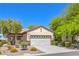 Well-kept home with desert landscaping, a two-car garage and stylish architectural details at 2550 Evening Twilight Ave, Henderson, NV 89044