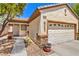 Beautiful home featuring a stone accent wall, a two-car garage and lovely landscaping at 2550 Evening Twilight Ave, Henderson, NV 89044