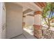 Close-up of a covered front porch with stone columns and desert landscaping at 2550 Evening Twilight Ave, Henderson, NV 89044