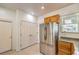 Updated kitchen featuring stainless steel refrigerator, ample storage, and access to the pantry at 2550 Evening Twilight Ave, Henderson, NV 89044