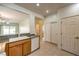 Bright kitchen with oak cabinets, tile flooring, and a view to the adjacent living area at 2550 Evening Twilight Ave, Henderson, NV 89044