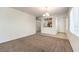 Spacious living room showcasing neutral tones, carpet flooring, and access to other rooms at 2550 Evening Twilight Ave, Henderson, NV 89044