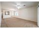 Spacious living room with neutral walls, carpet, and view of the kitchen, perfect for gatherings at 2550 Evening Twilight Ave, Henderson, NV 89044