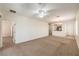 Open living space with carpet, ceiling fan, and view of the kitchen, ideal for entertaining or relaxing at 2550 Evening Twilight Ave, Henderson, NV 89044