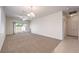 Open living room featuring carpet flooring, ample natural light, and convenient patio access at 2550 Evening Twilight Ave, Henderson, NV 89044