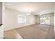 Spacious living area with carpet and a sliding glass door to the backyard at 2550 Evening Twilight Ave, Henderson, NV 89044
