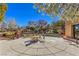 Relax in the outdoor patio area with ample seating, mature trees, and landscaped surroundings at 2550 Evening Twilight Ave, Henderson, NV 89044