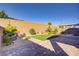 Well-maintained backyard featuring brick pavers, desert landscaping and a brick wall at 2628 Ferrara St, Henderson, NV 89044