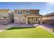 Cozy backyard featuring a manicured lawn, brick pavers and a view of the two-story home at 2628 Ferrara St, Henderson, NV 89044