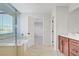 Bathroom featuring a glass-enclosed shower, double vanity, and tile flooring at 2628 Ferrara St, Henderson, NV 89044