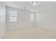 Well-lit bedroom with carpeted floors and two windows at 2628 Ferrara St, Henderson, NV 89044