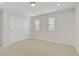 Bright bedroom featuring two double-hung windows and sliding closet doors at 2628 Ferrara St, Henderson, NV 89044