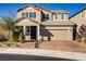 Inviting two-story home boasts a brick driveway, neutral exterior, and well-maintained landscaping at 2628 Ferrara St, Henderson, NV 89044